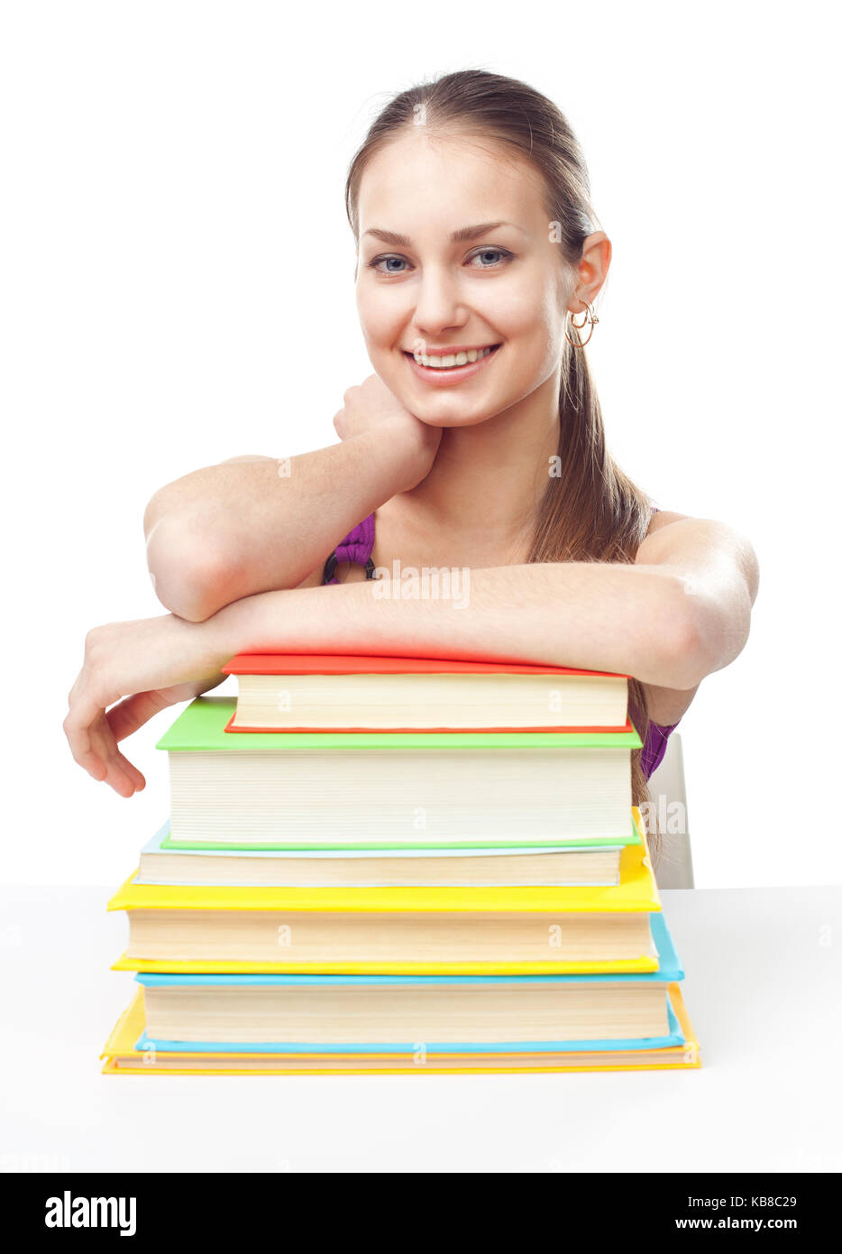 Portrait of pretty young happy smiling student girl with pile of books ...
