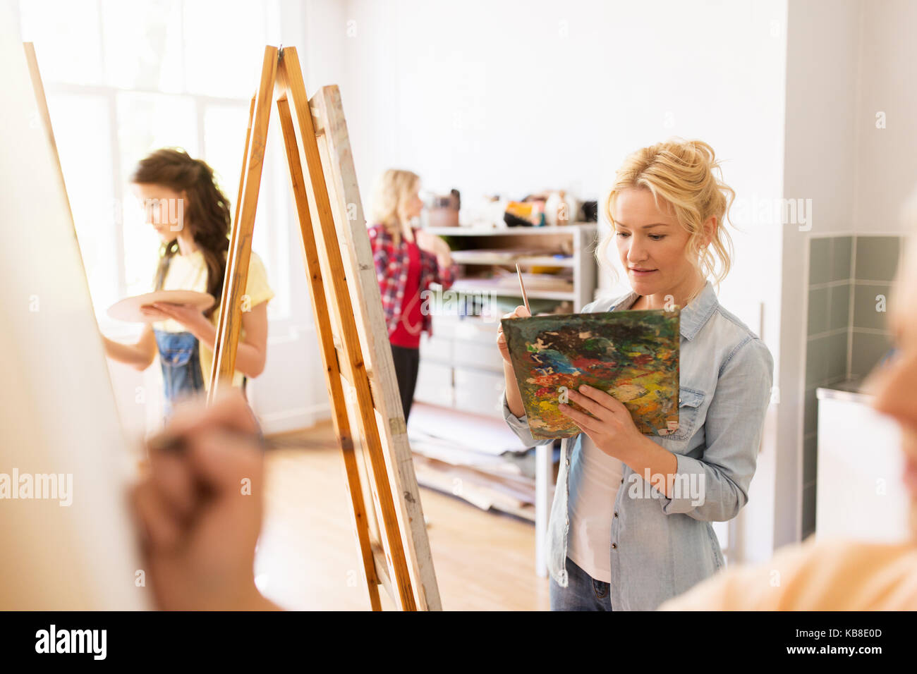 woman artist with easel painting at art school Stock Photo - Alamy