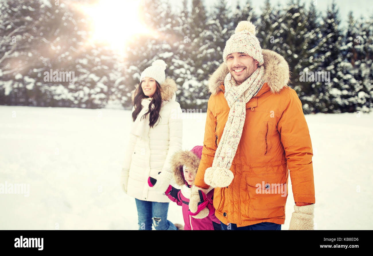 happy family in winter clothes walking outdoors Stock Photo - Alamy