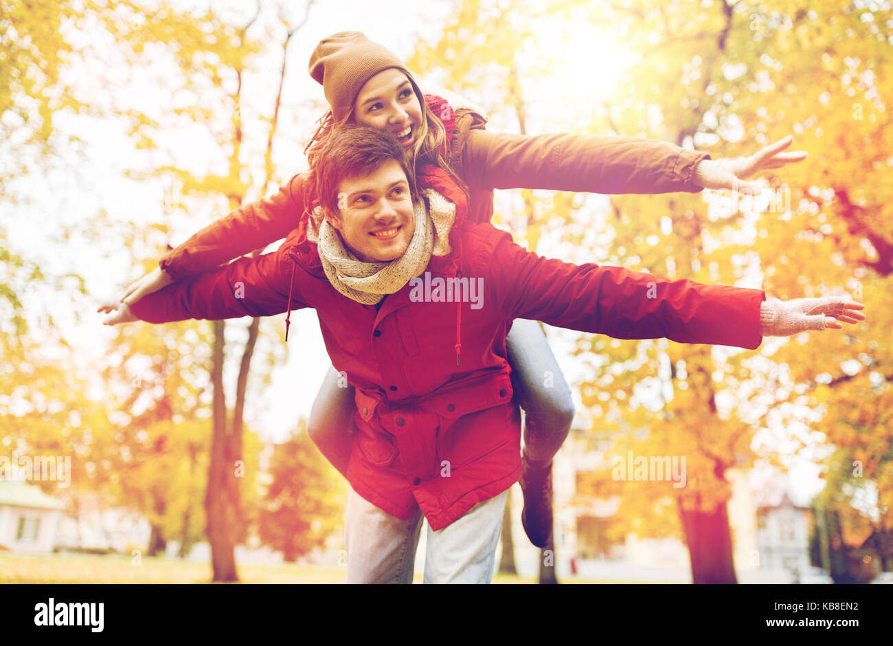 happy young couple having fun in autumn park Stock Photo - Alamy