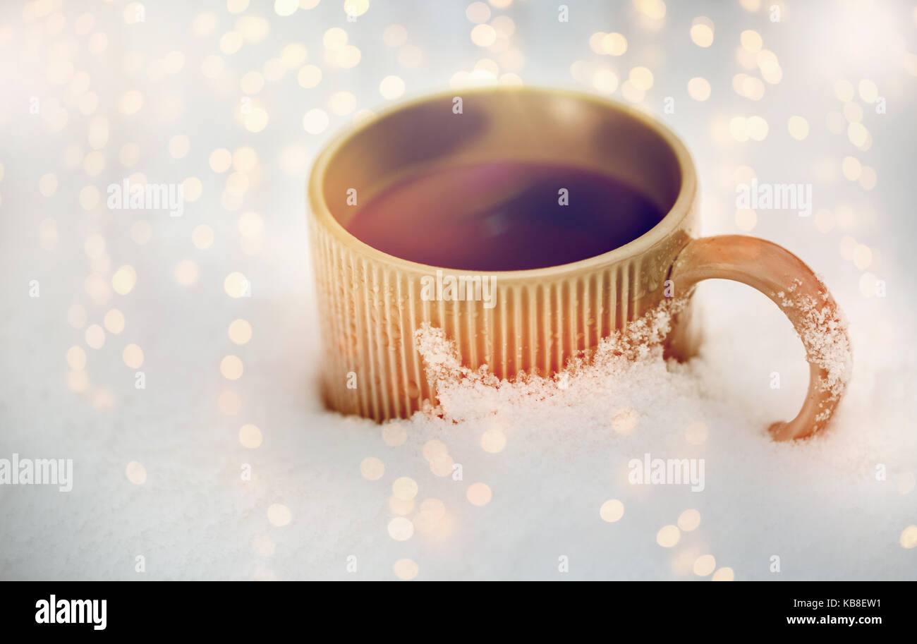 Red mug with hot coffee or tea drink on snow in winter Stock Photo by  molenira