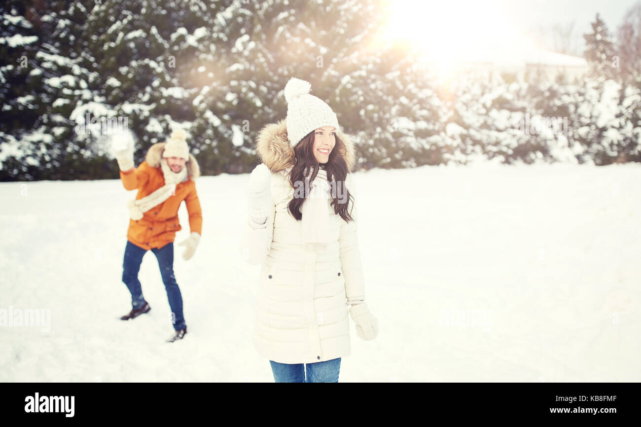 happy couple playing snowballs in winter Stock Photo - Alamy