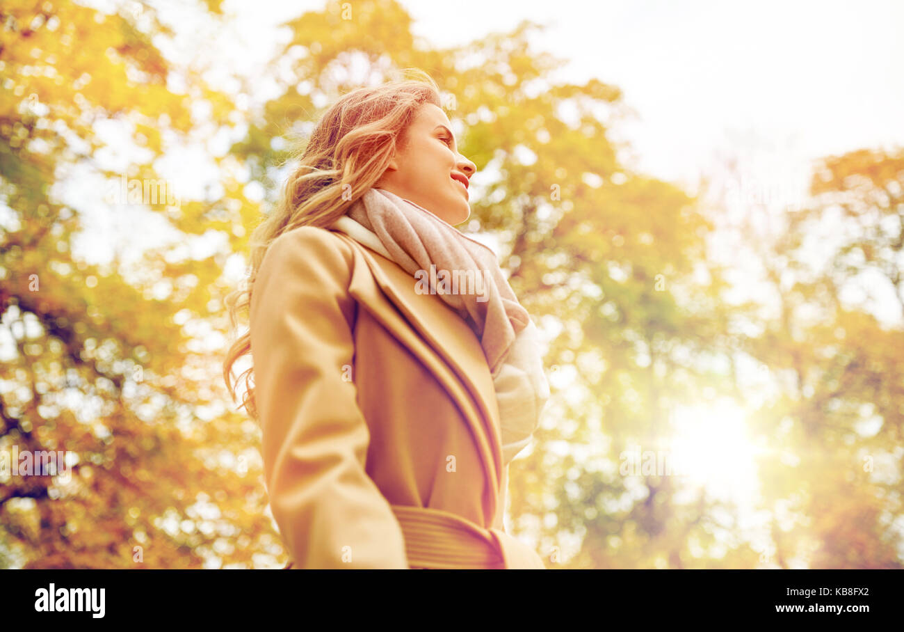 beautiful happy young woman smiling in autumn park Stock Photo - Alamy