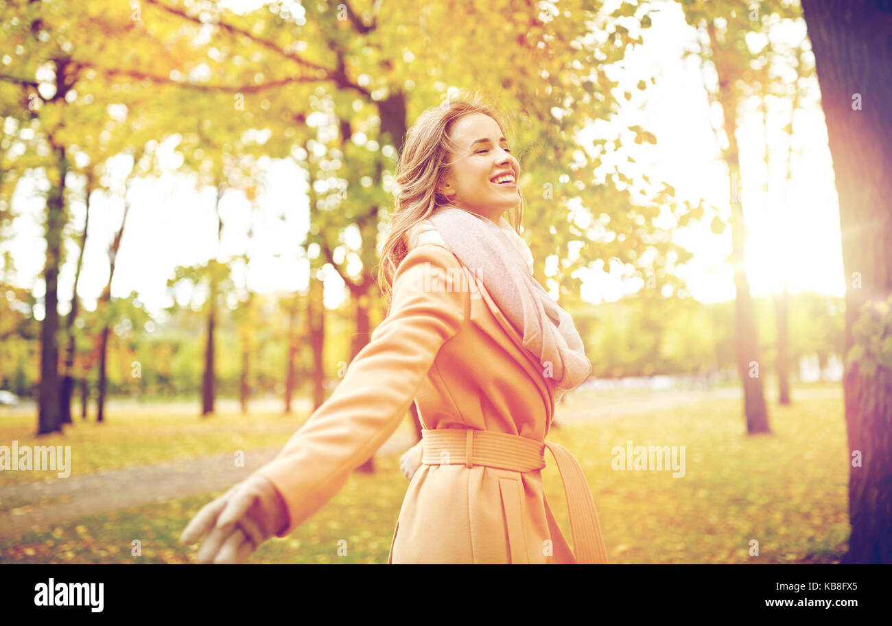 beautiful happy young woman walking in autumn park Stock Photo - Alamy