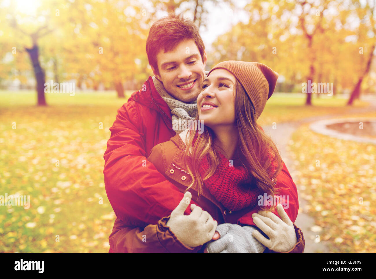 happy young couple hugging in autumn park Stock Photo - Alamy