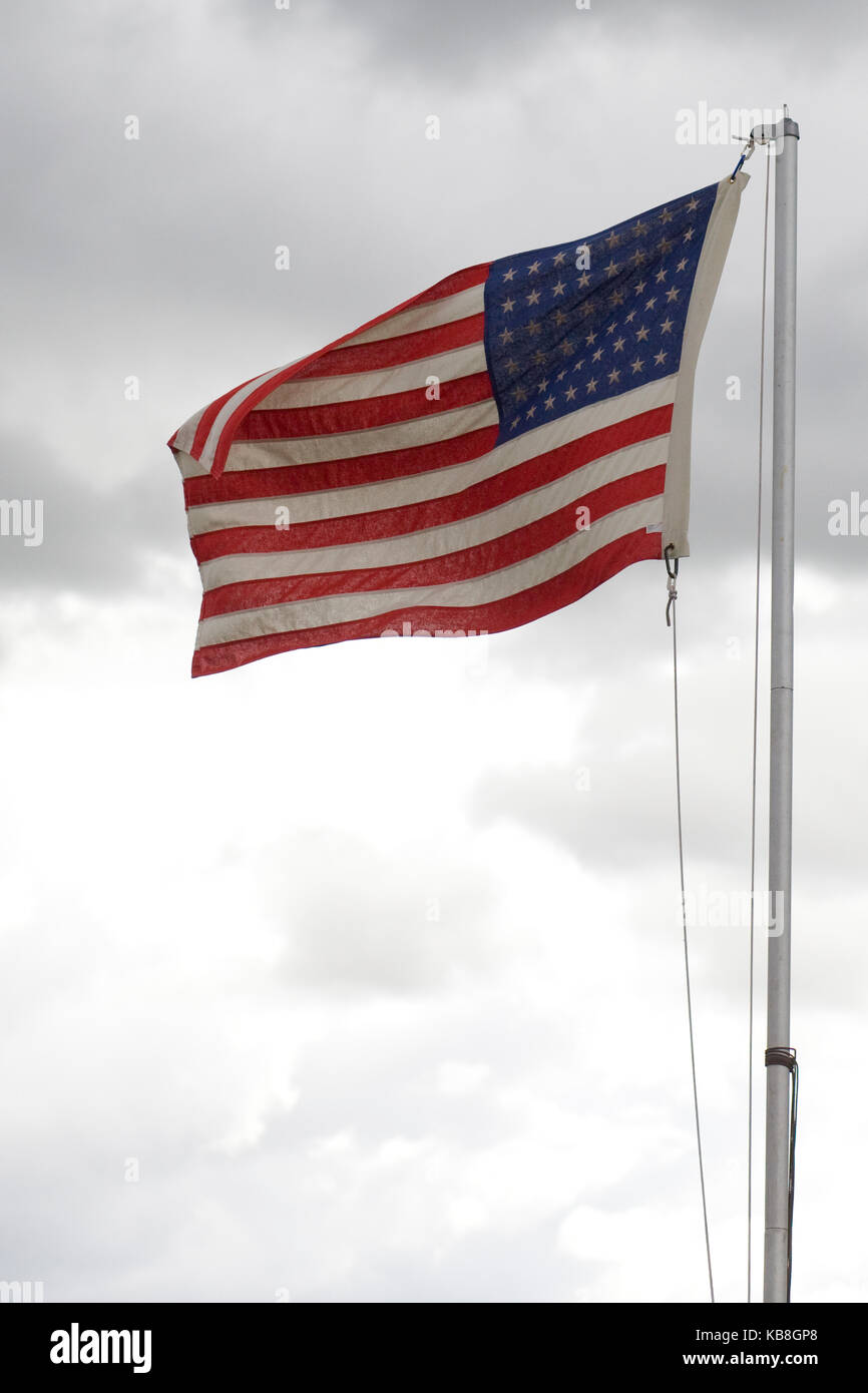 American flag flying on an overcast day Stock Photo