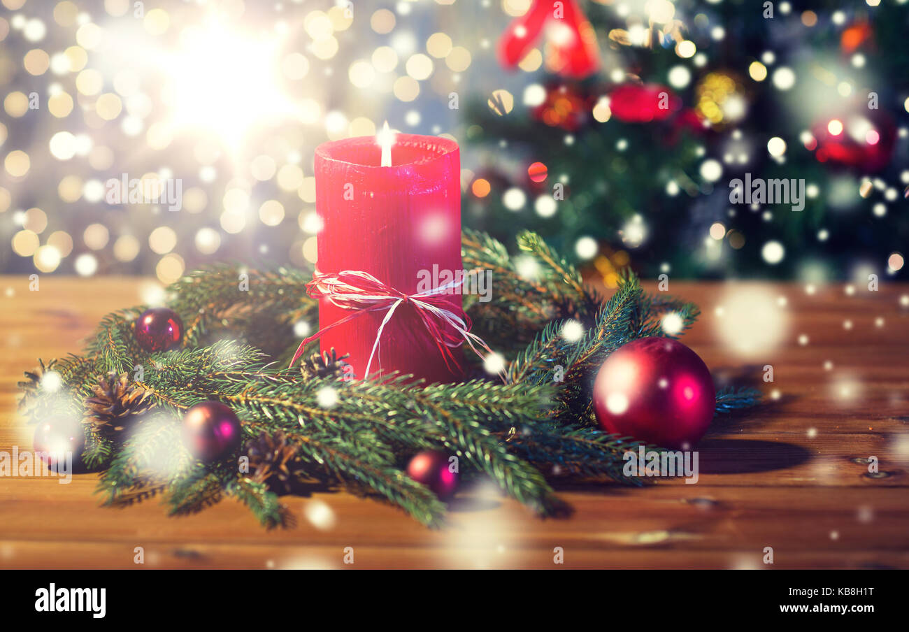 fir branch wreath with candle on wooden table Stock Photo