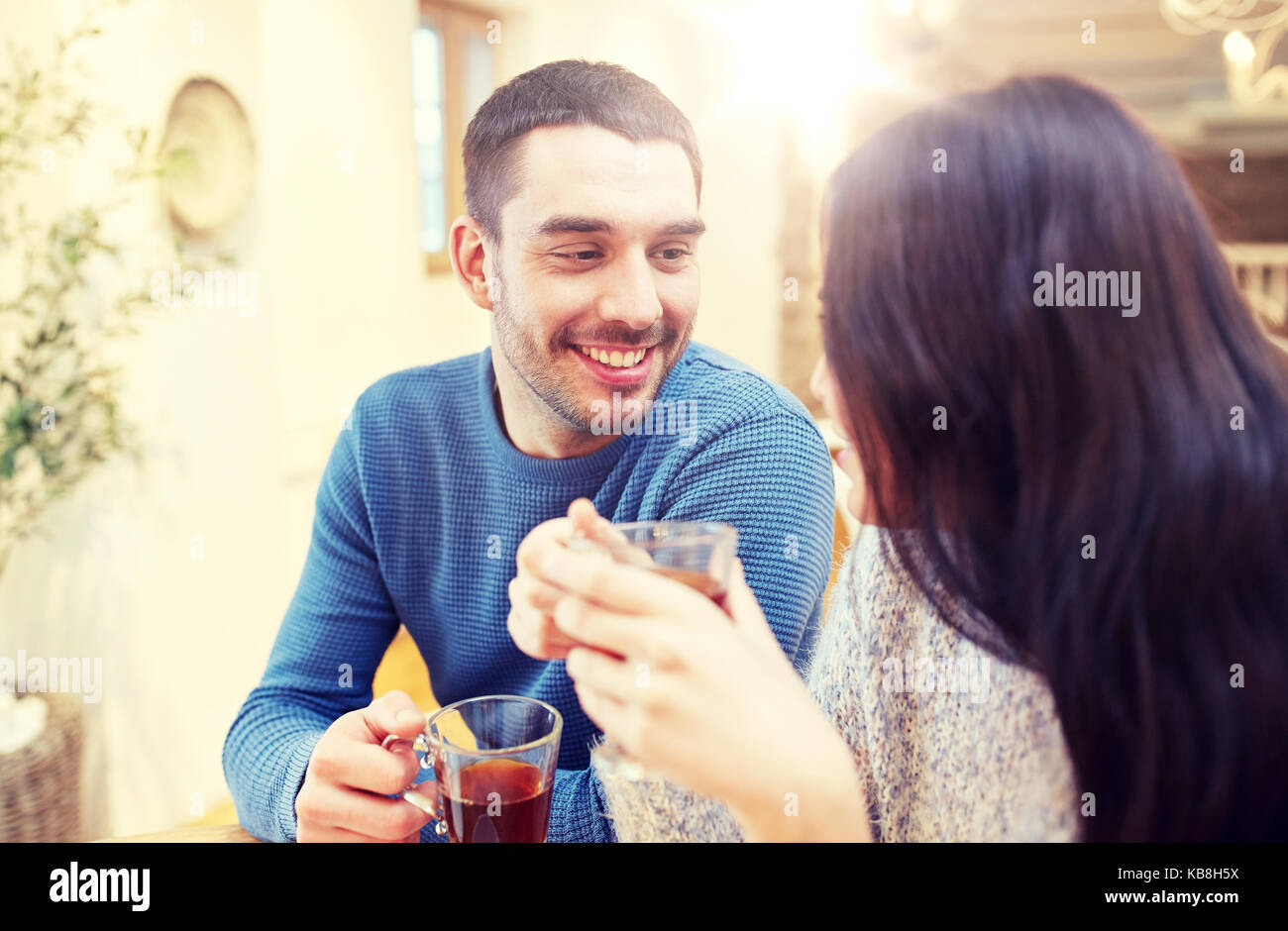 happy couple drinking tea at cafe Stock Photo Alamy