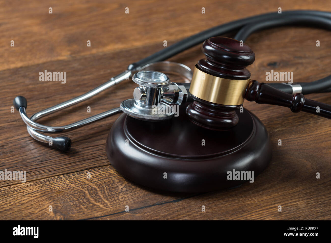 Closeup of gavel and stethoscope on table in courtroom Stock Photo