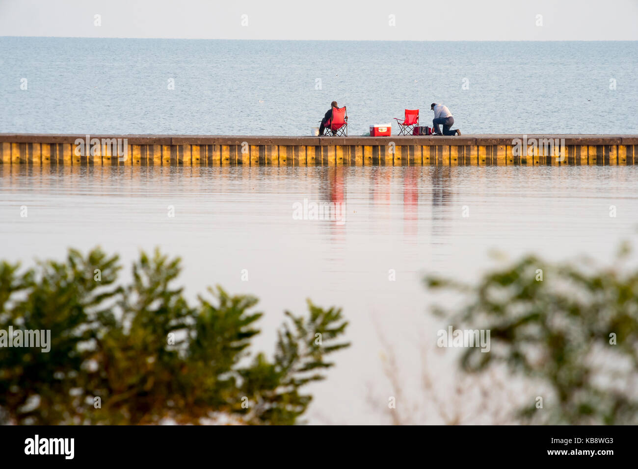 fishermen on pier in Lake Erie Stock Photo