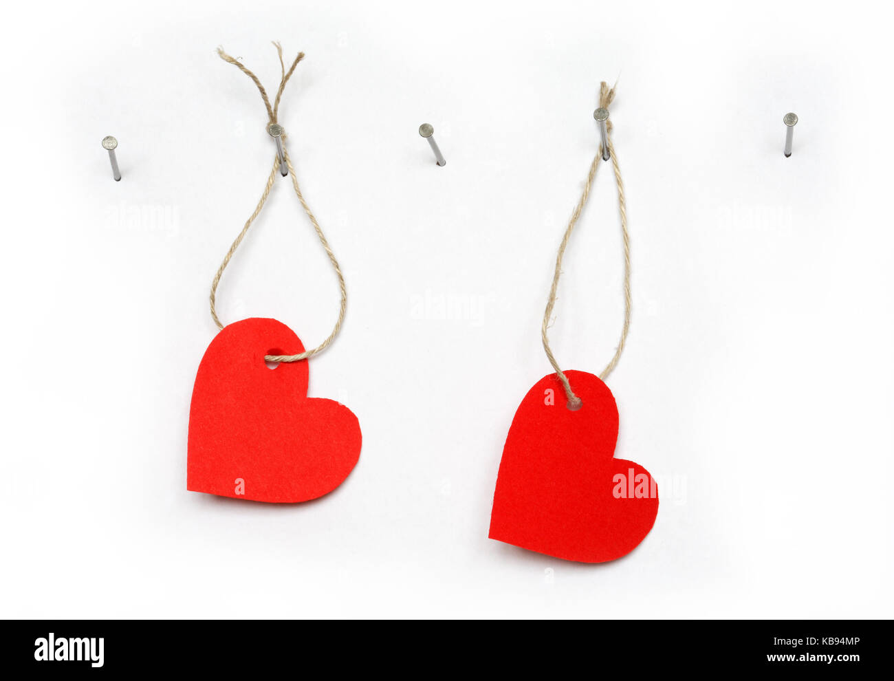 Red paper hearts hanging on white background with rope and nail Stock ...