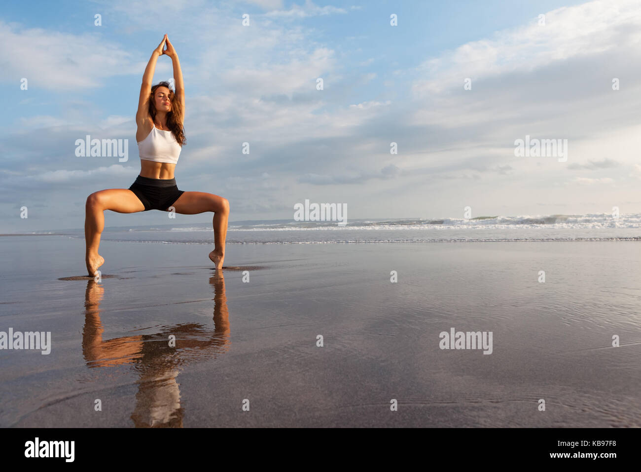 Meditation on sunset sky background. Young active woman in yoga