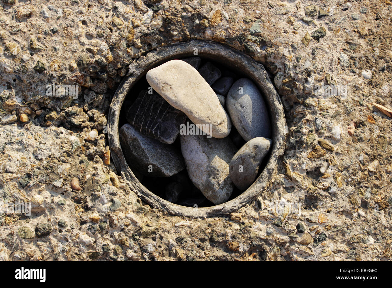 Large concrete rectangular blocks to protect the shore from erosion. Enclosure of railroad tracks. A lot of granite stones were poured into the hole Stock Photo