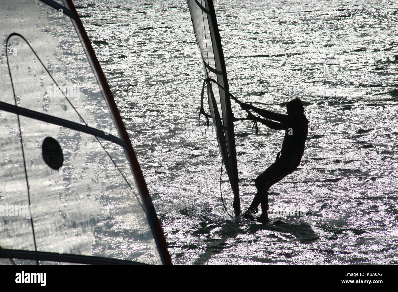 Surfer on surfboard with sail Surfer auf Surfboard mit Segel Stock