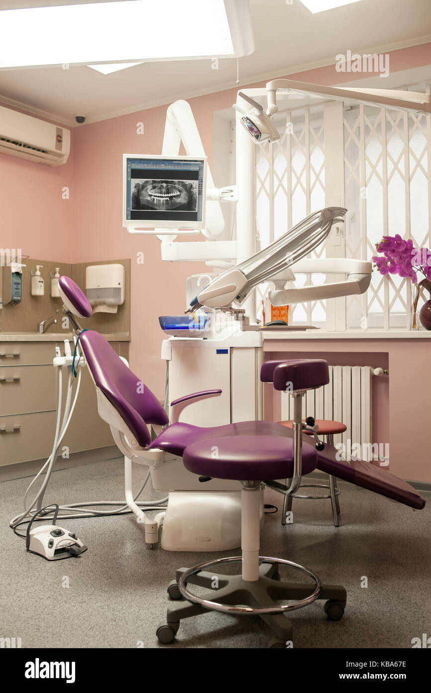 Interior of modern dental clinic office with dental unit, equipment, computer, monitor screen