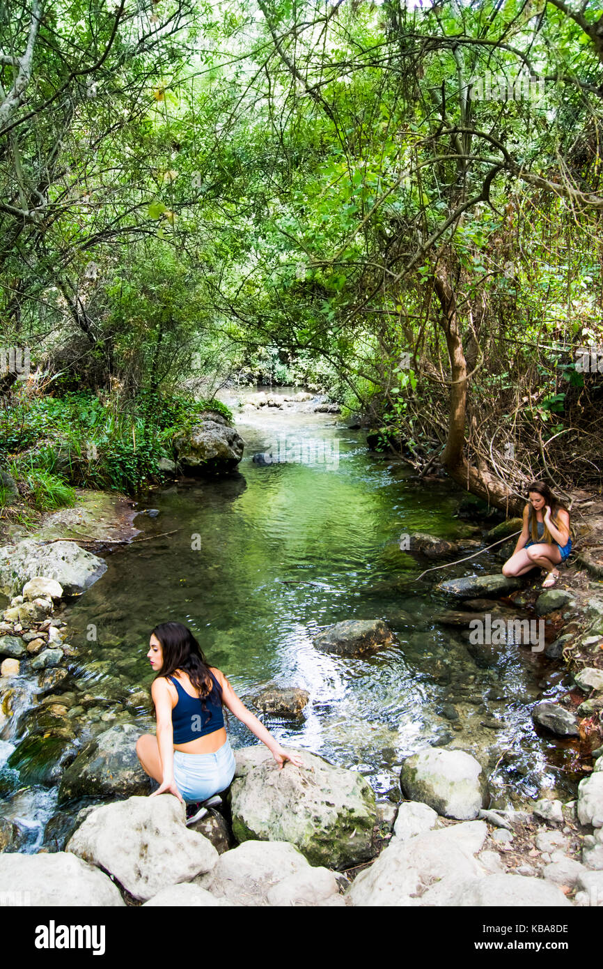 Two beautiful women in nature on the bank of a mountain river Stock ...