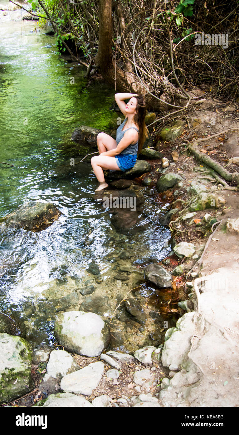 Beautiful woman in nature on the bank of a mountain river Stock Photo ...