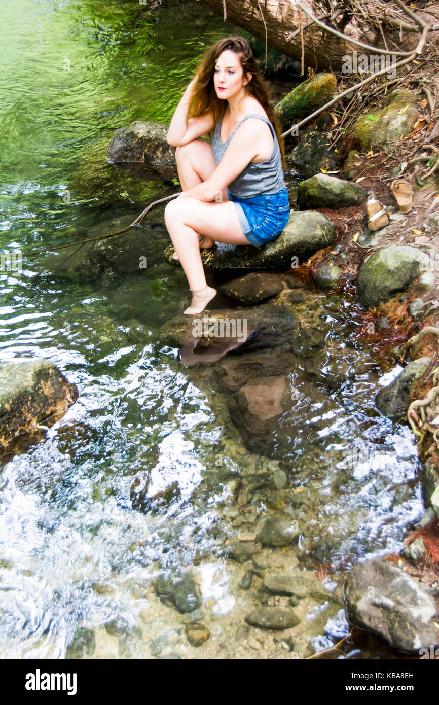 Beautiful woman in nature on the bank of a mountain river Stock Photo ...