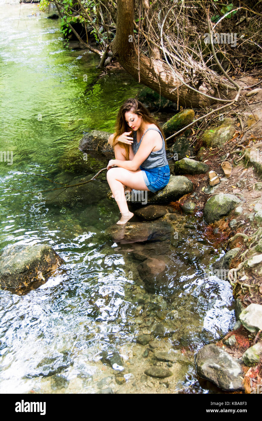 Beautiful woman in nature on the bank of a mountain river Stock Photo ...
