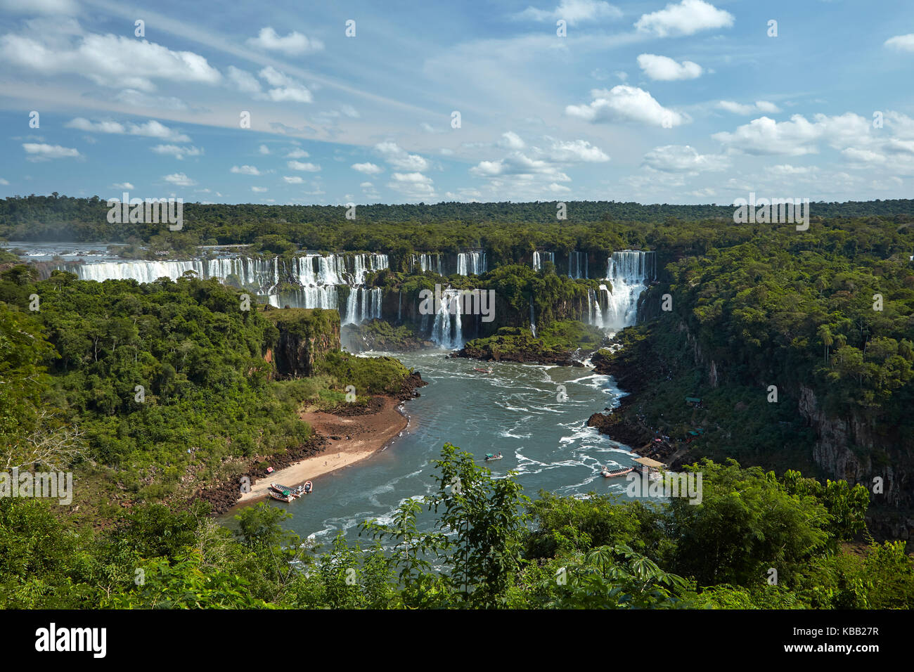 Iguazu Falls on Argentina side, and tourist boats on Iguazu River, Brazil - Argentina Border, South America Stock Photo