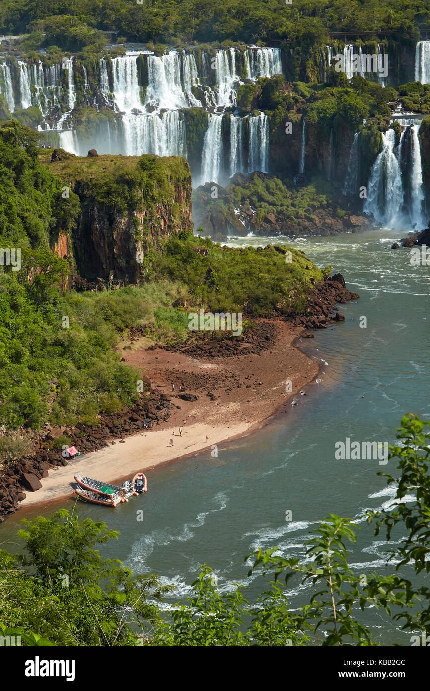 Iguazu Falls on Argentina side, and tourist boats on Iguazu River, Brazil - Argentina Border, South America Stock Photo