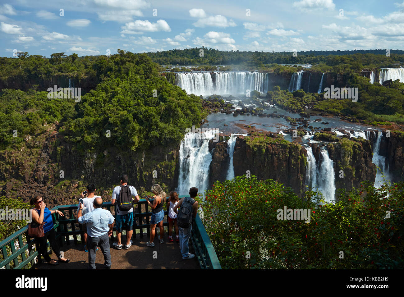 Tourists on viewing platform on Brazil side of Iguazu Falls, looking at Argentinian side, South America Stock Photo