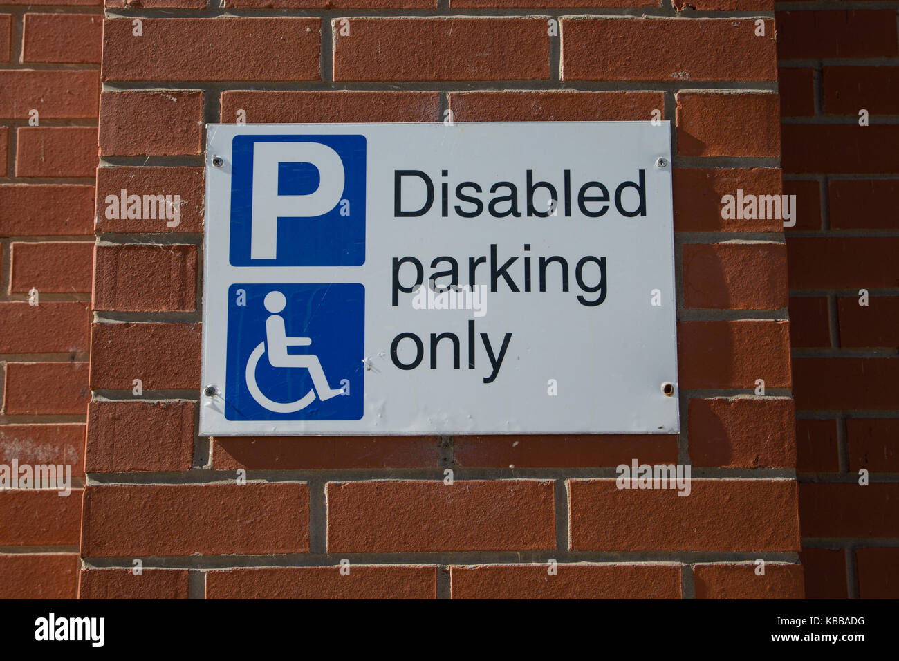Diabled Parking only sign on brick wall Stock Photo - Alamy
