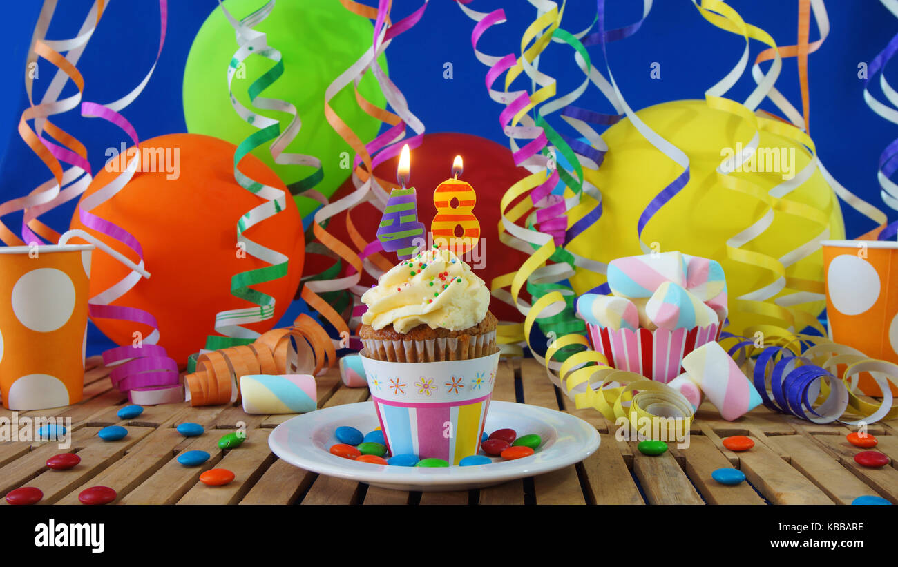 48 Birthday cupcake with candles burning on rustic wooden table with ...