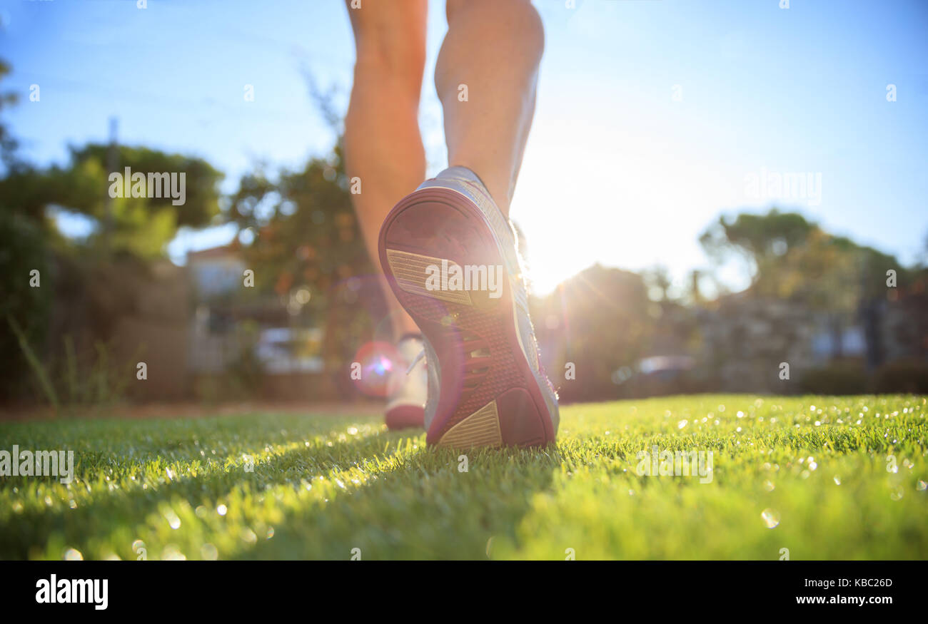 Woman runner running in nature, closeup on shoes Stock Photo