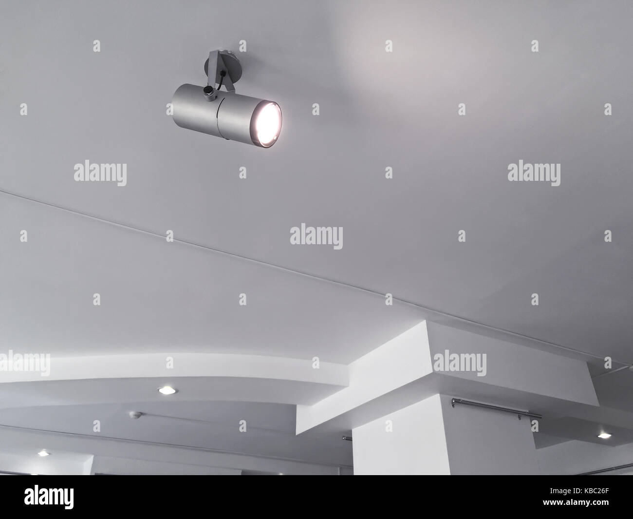 exhibition lighting system. bright halogen spotlights on exhibition ceiling. Stock Photo