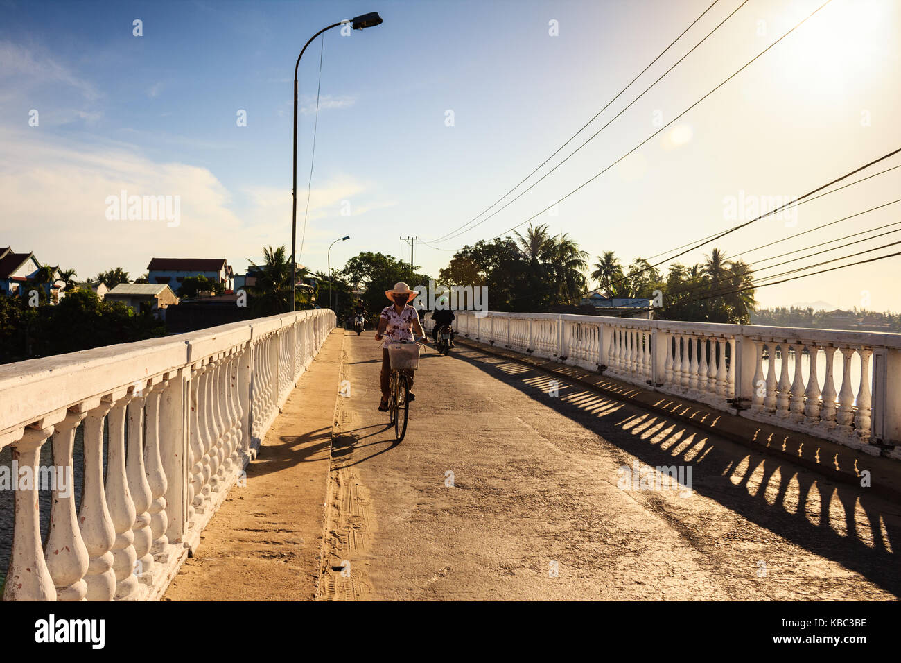 A local woman is on the bridge, Quang Nam, Vietnam. Quang Nam has 2 UNESCO World Heritage Sites: Hoi An ancient town and the My Son temple complex Stock Photo