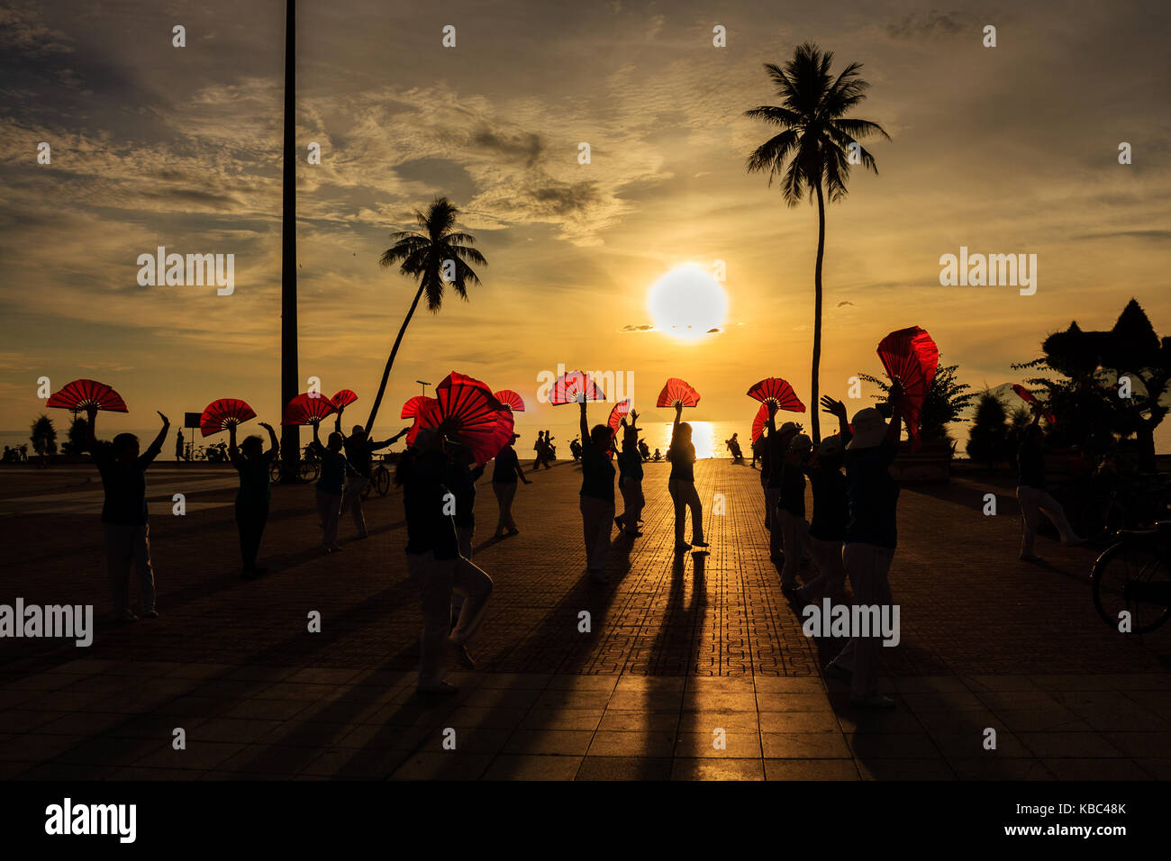 Local people exercise in sunrise at Nha Trang beach, Khanh Hoa, Vietnam. Stock Photo