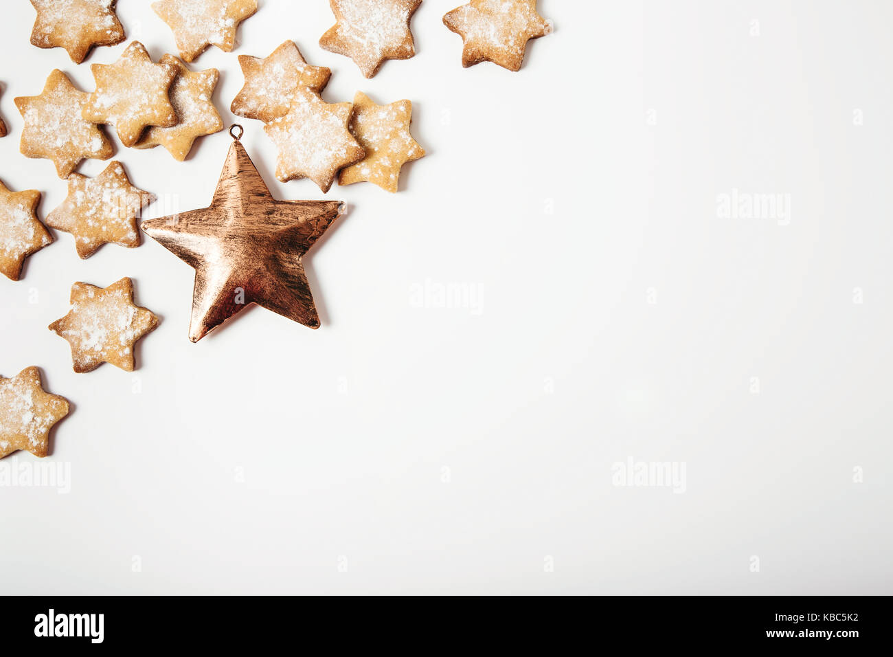 Christmas frame.gingerbread stars with golden metal star.Christmas decoration.White background. Stock Photo