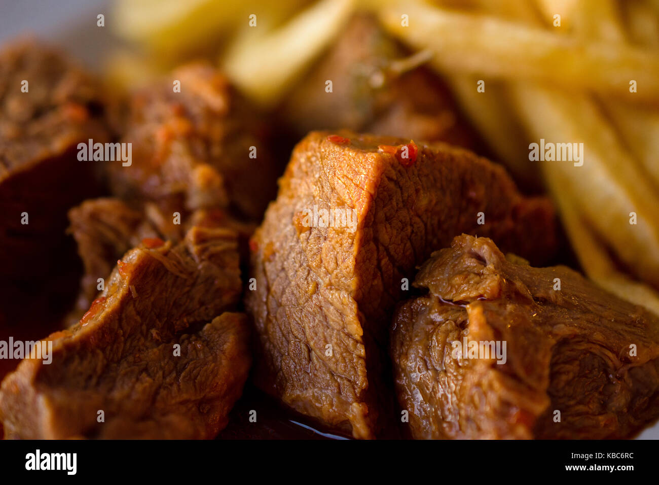 CloseUp Of Delicious Meal Of Beef Stew In Sauce With French Fries
