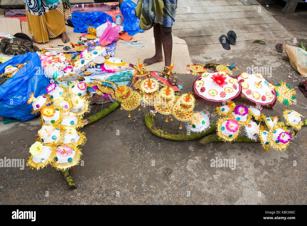 Vendor selling fresh flowers, vegetables, fruits and umbrella for devotees to bless Hindu god Ganesh at local market on the first day of Ganesh Chatur Stock Photo