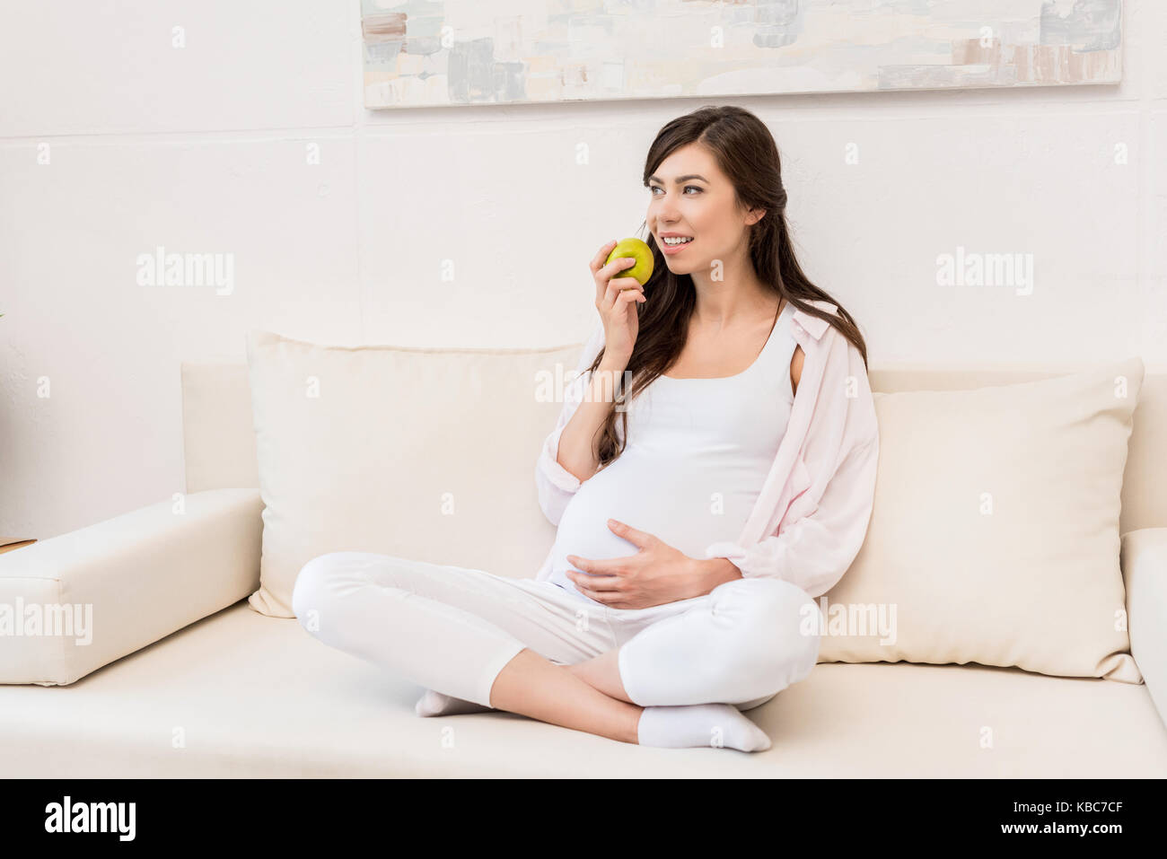 Pregnant woman eating apple Stock Photo Alamy