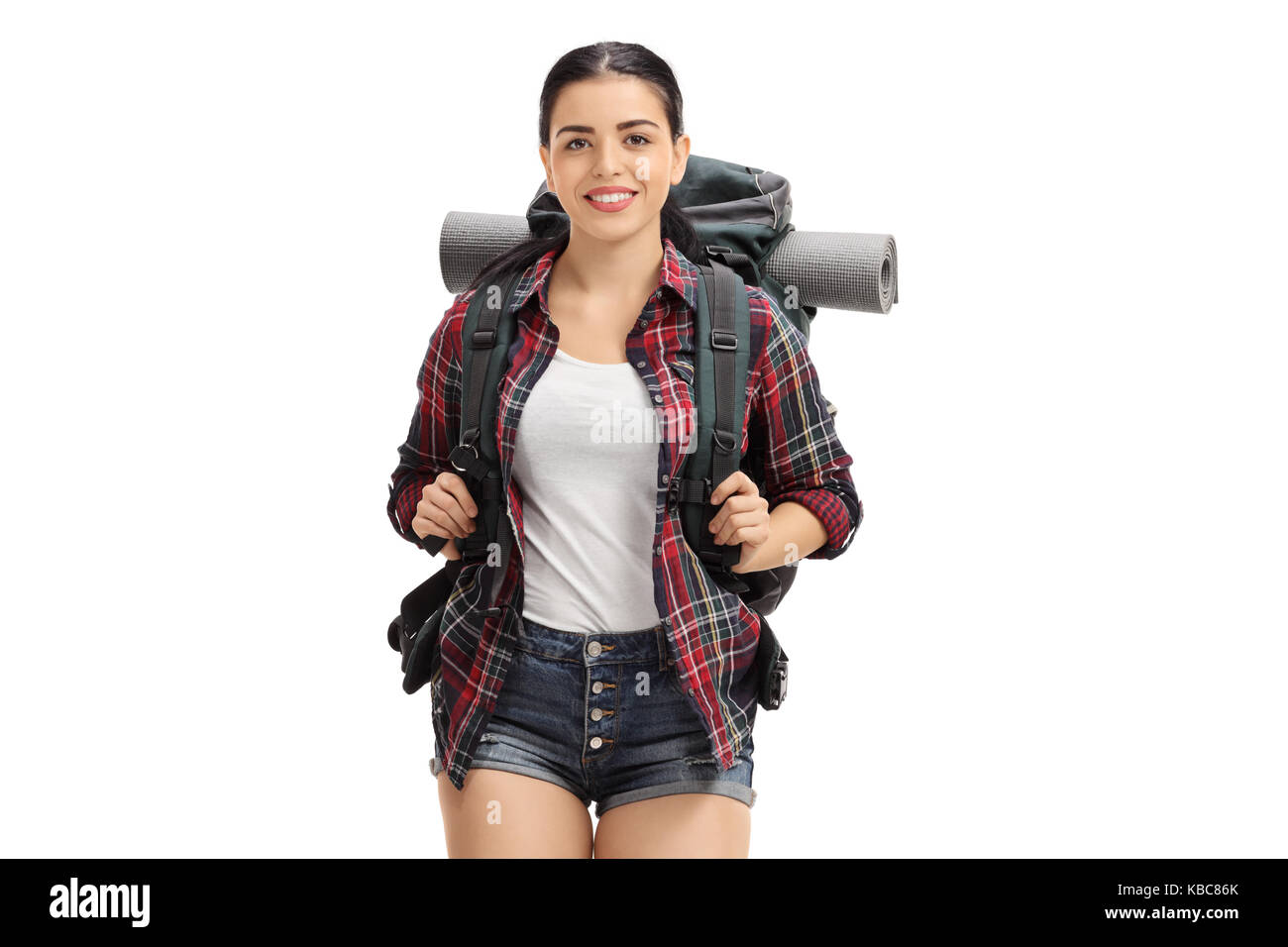 Female hiker with a backpack looking at the camera and smiling isolated on white background Stock Photo