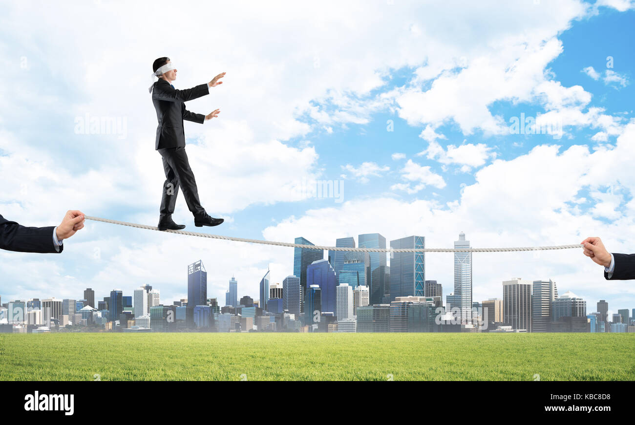 Business concept of risk support and assistance with man balancing on ...