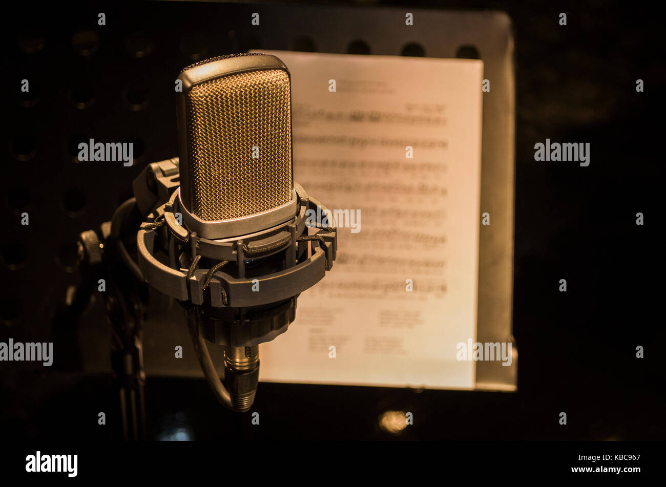 Retro microphone on stage a background of musical note Stock Photo