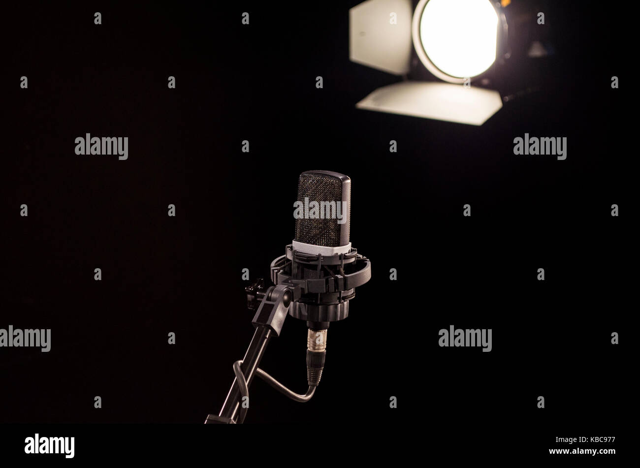 Retro microphone on stage a background of studio light Stock Photo