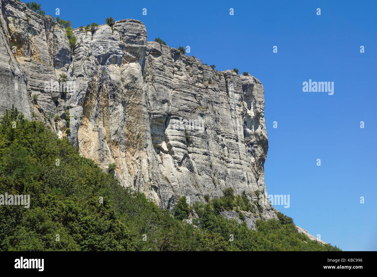 Giant sharp stones among the grass on the top of mountain meadows in vertical mountain landscape Stock Photo