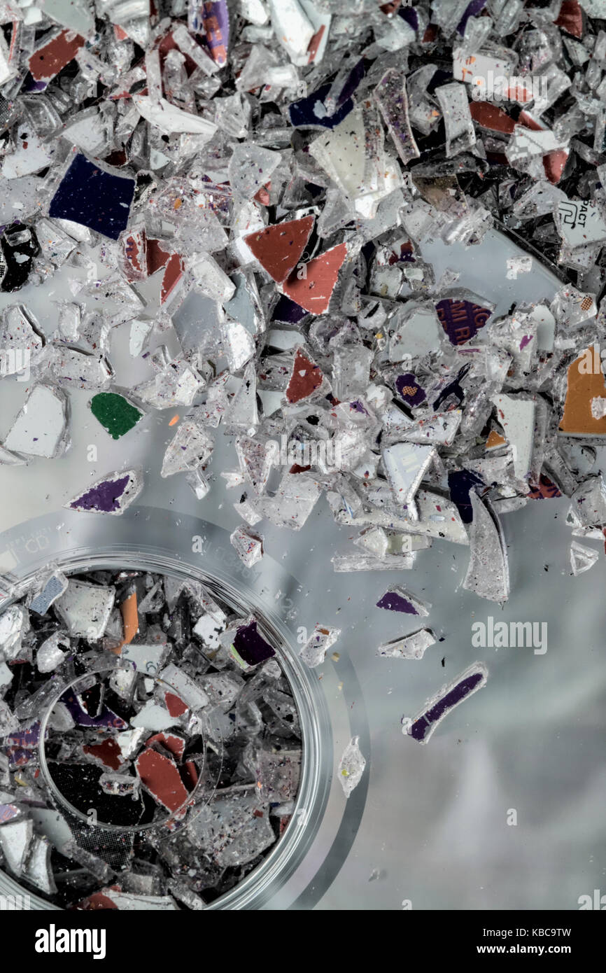 Granules of shredded plastic waste from CD & DVD manufacture. Stock Photo