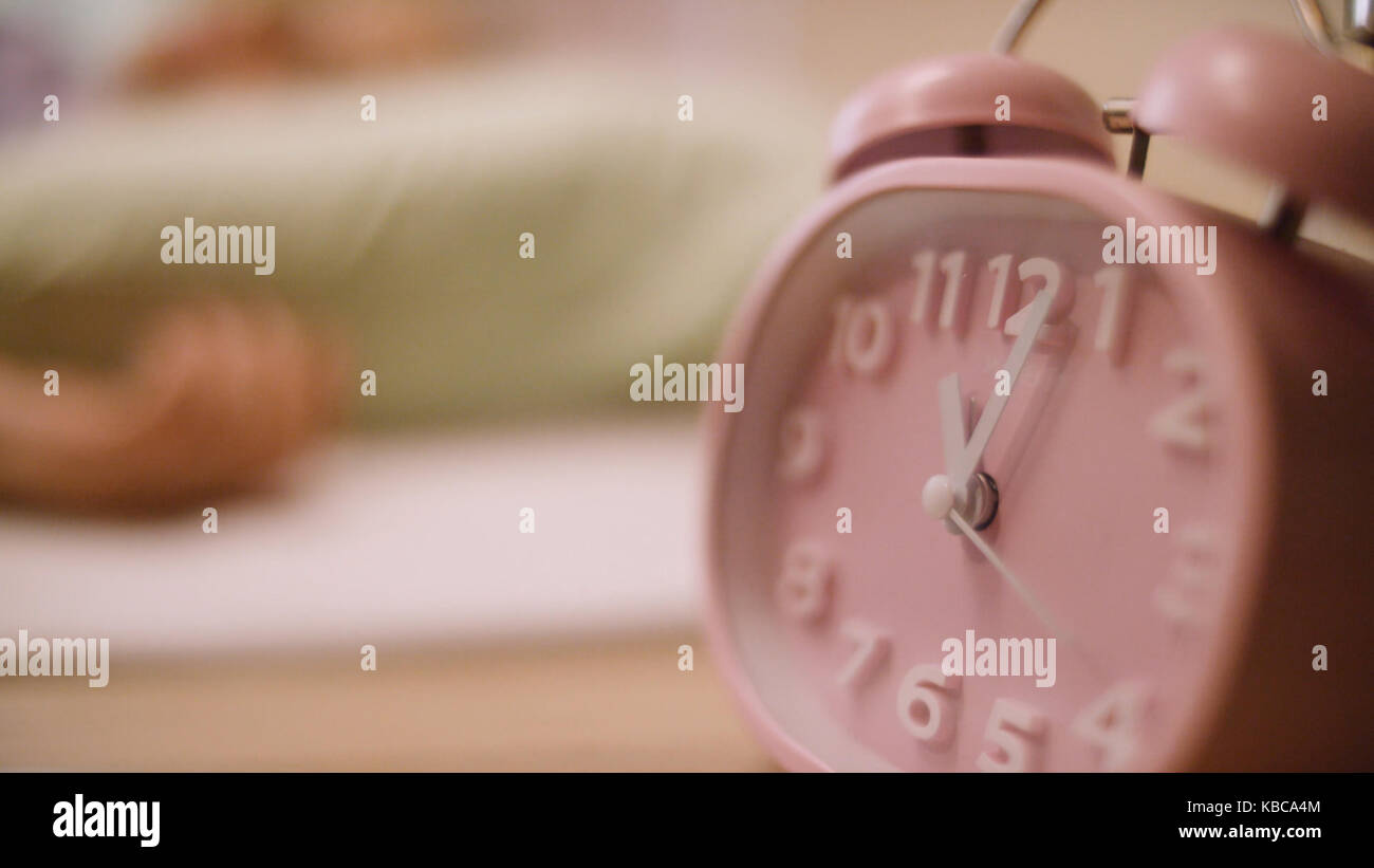 Pink alarm clock. Pink clock standing on the nightstand Stock Photo Alamy