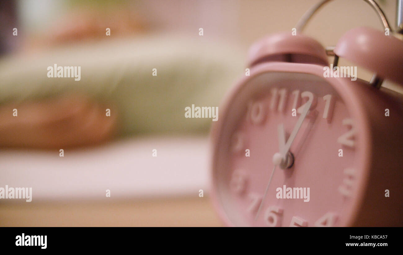 Pink alarm clock. Pink clock standing on the nightstand Stock Photo Alamy