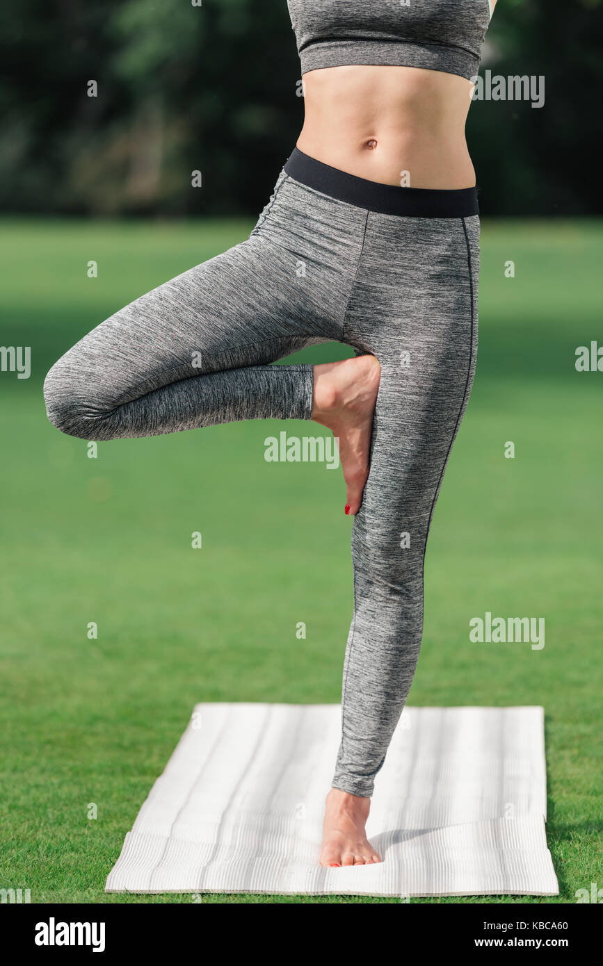 woman practicing yoga tree pose Stock Photo - Alamy