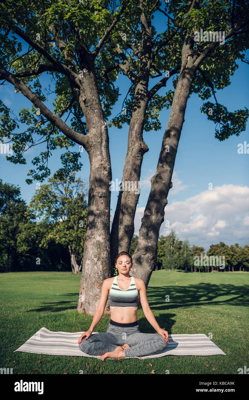 caucasian woman practicing lotus pose Stock Photo