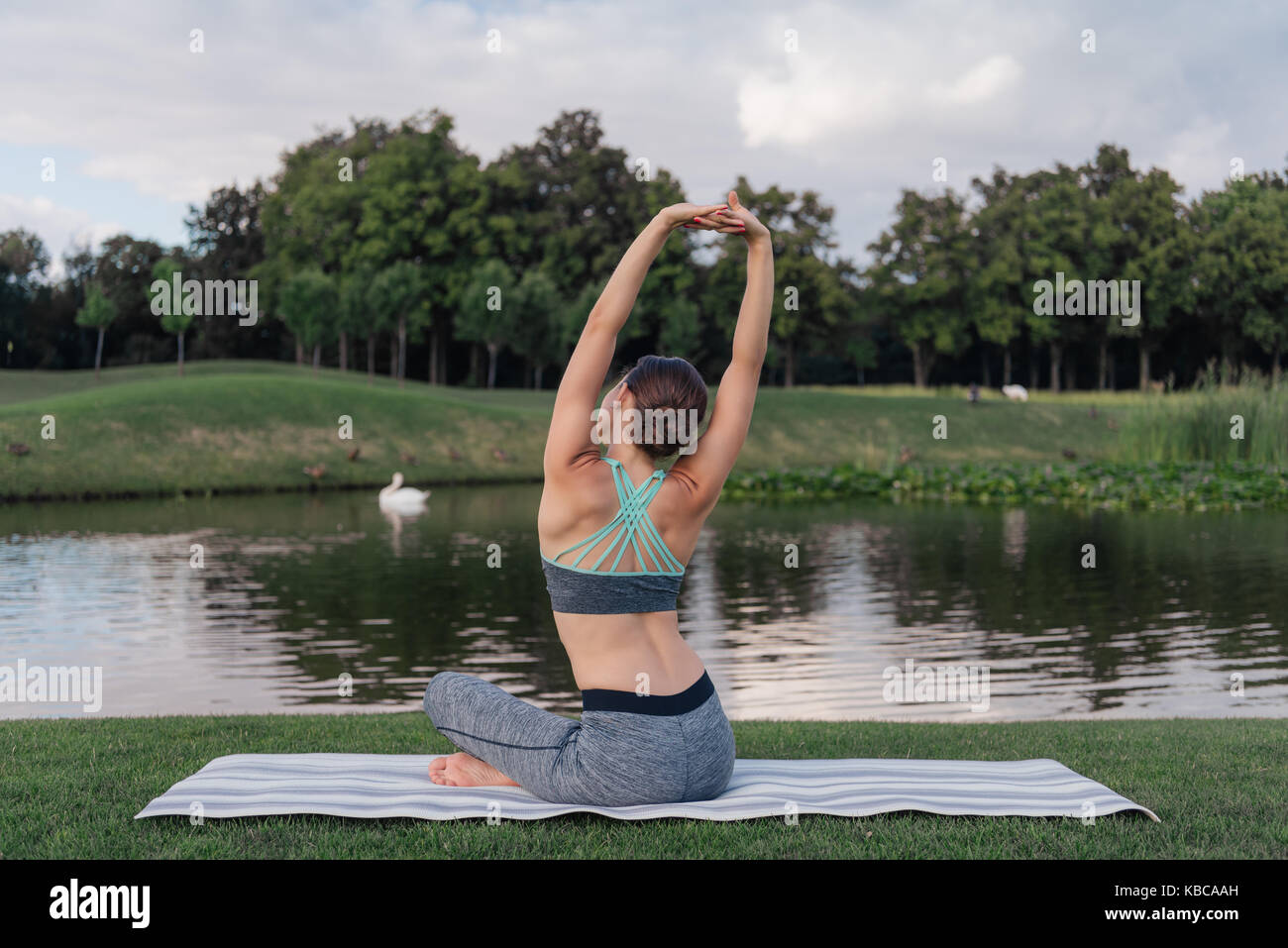 woman stretching on yoga mat Stock Photo - Alamy