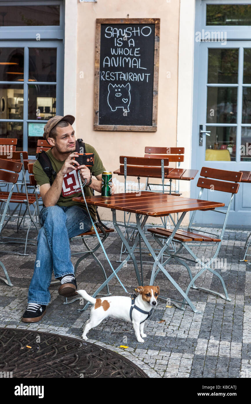 Man with a dog in a restaurant, Old Town, Prague, Czech Republic man and dog Stock Photo
