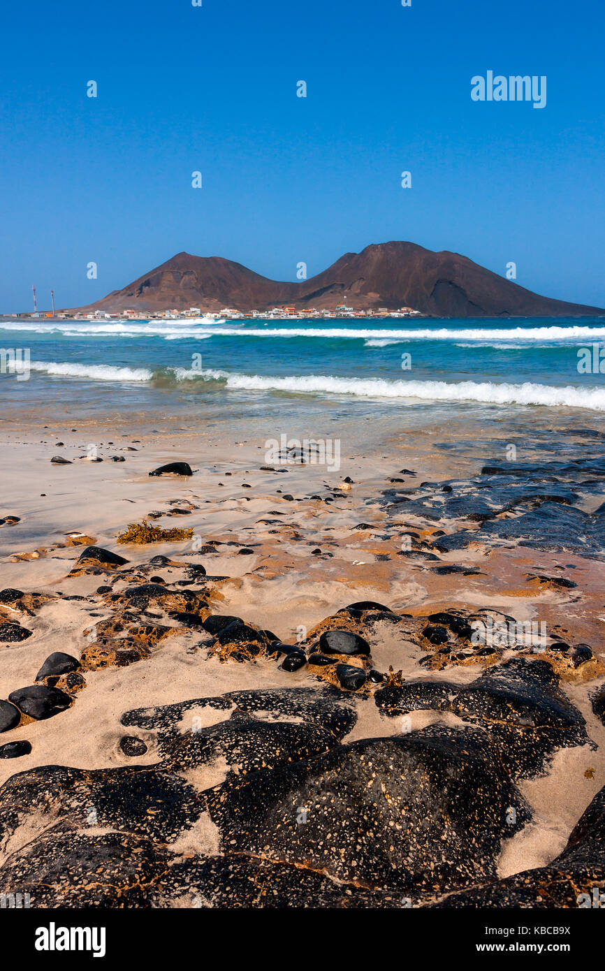 Volcanic basalt rocks on the beach at the Atlantic Ocean. Calhau town, extinct volcano crater in Cape Verde, Sao Vicente Island Stock Photo