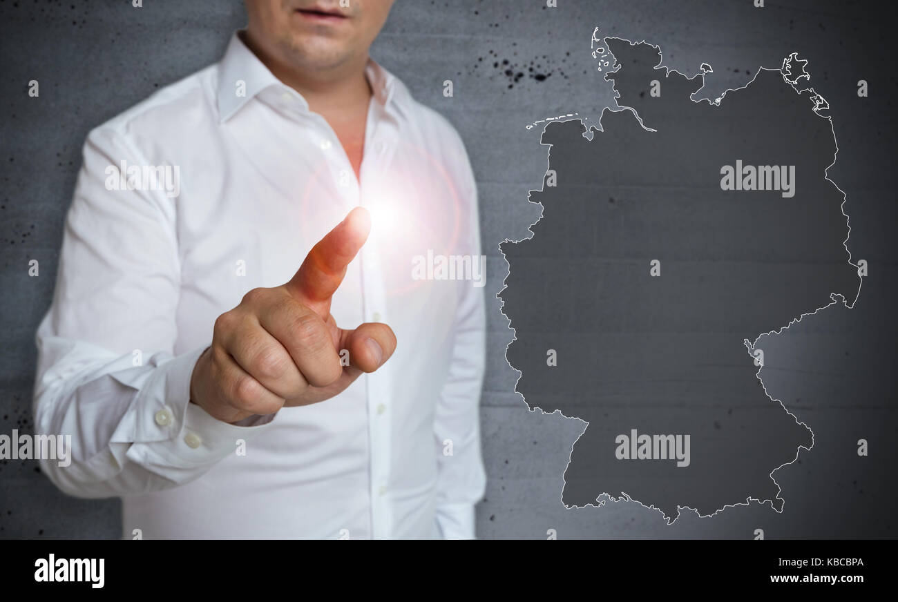 Germany map touchscreen is operated by man. Stock Photo
